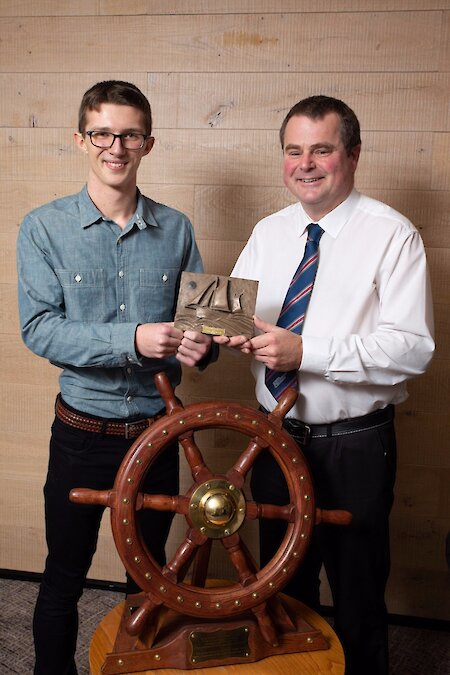 Cormac Mathieson receives the Vevoe Trophy for Sail Trainee of the Year 2018, from Aubrey Jamieson of RNMDSF.